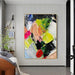 Textured knife abstract oil painting with bold colors and dynamic shapes on a vertical canvas in a modern living room setting.