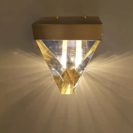 Luxury crystal wall lamp sconce with LED light, featuring a gold metal frame and a radiant glass shade for elegant home decor.