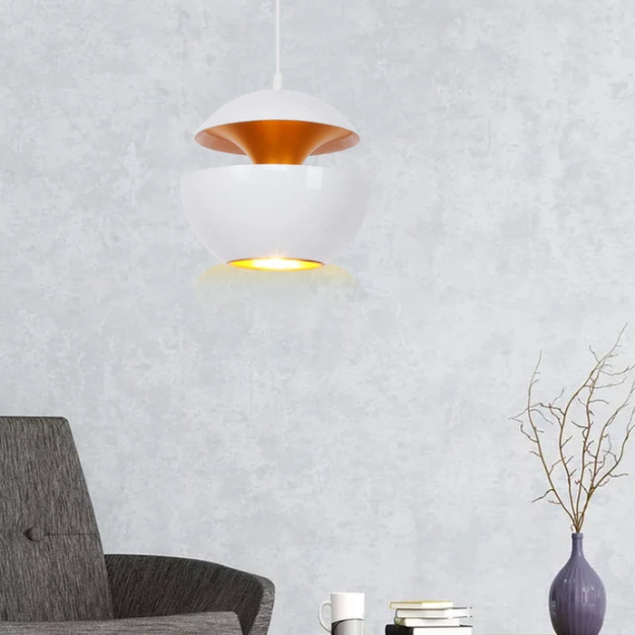 Elegant apple pendant light in modern living room interior with grey walls and minimalist furniture.