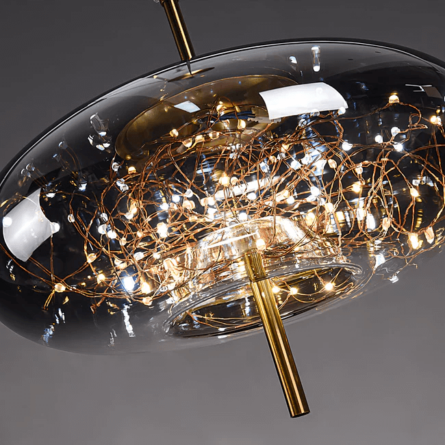 Starburst Glass Dome Pendant Light with golden burst effect and warm glow, ideal for cozy ambiance in small spaces.