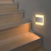 Modern LED recessed footlight illuminating staircase with a contemporary design, perfect for hallways and living areas.