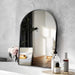 Large arch mirror with modern aluminum frame reflecting a stylish room, perfect for bathrooms and bedrooms.