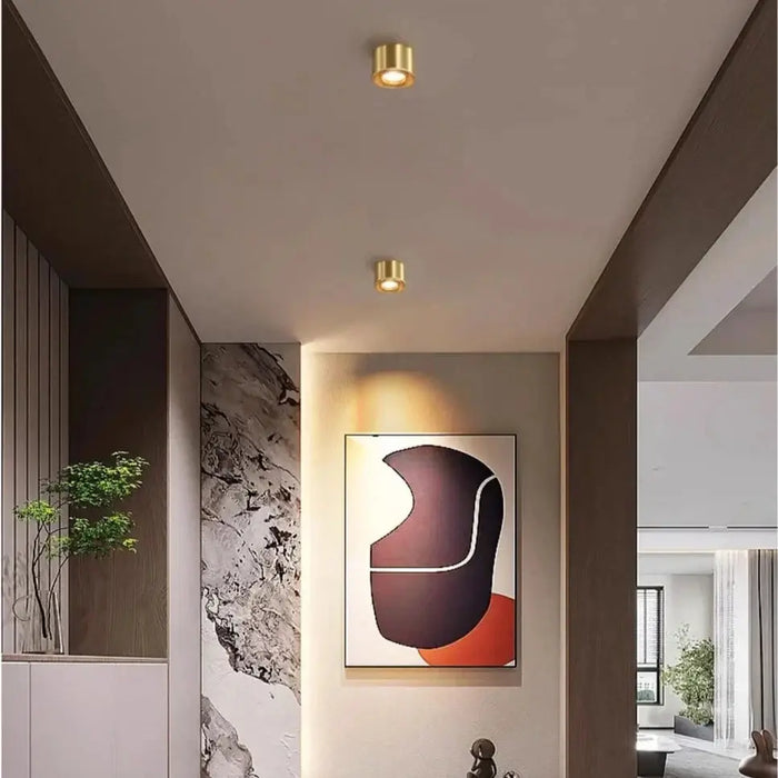 Elegant copper LED ceiling light in modern interior setting, highlighting adjustable lighting and stylish décor.