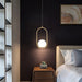 Modern Cage Chandelier in bedroom setting, LED light fixture with iron frame, ideal for parlors, studies, and bedrooms.