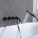 Wall-mounted dual-control matte black bathroom faucet set with handheld shower sprayer over a white bathtub.