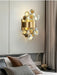 Modern luxury LED crystal wall lamp installed above a bed in a stylish bedroom setting.