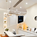 Modern kitchen interior with pendant lights and sleek white countertops.