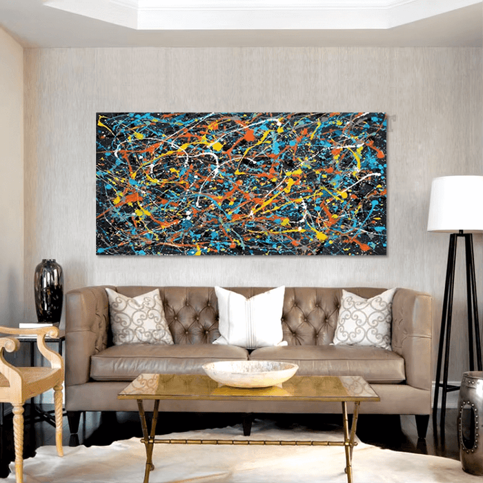 Vibrant Pollock-inspired abstract canvas with explosive colors on a wall above a leather sofa in a modern living room.