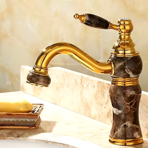 Luxury brass and jade basin faucet with gold finish, deck-mounted design, and elegant single-handle control for modern bathrooms.