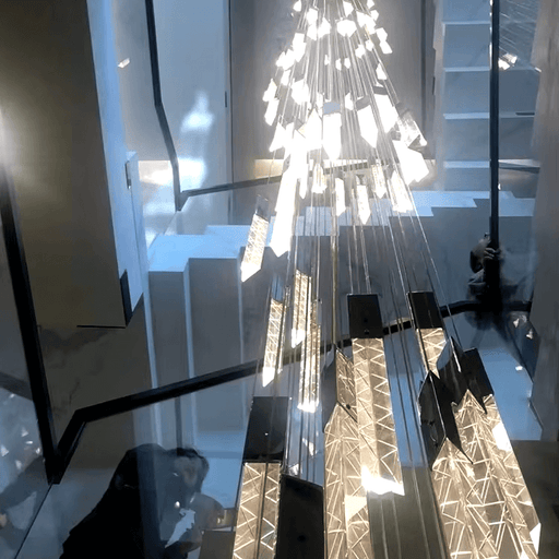 Modern crystal LED pendant chandelier illuminating a staircase with elegant stainless steel and crystal design.