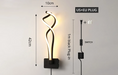 Modern artistic wall lamp with LED lighting, black plug-in cord, and sleek aluminum design, ideal for contemporary home decor.