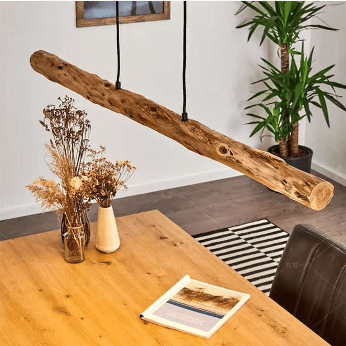 Rustic wooden LED pendant light hanging over a wooden dining table with plants and decor, creating a warm and inviting atmosphere.