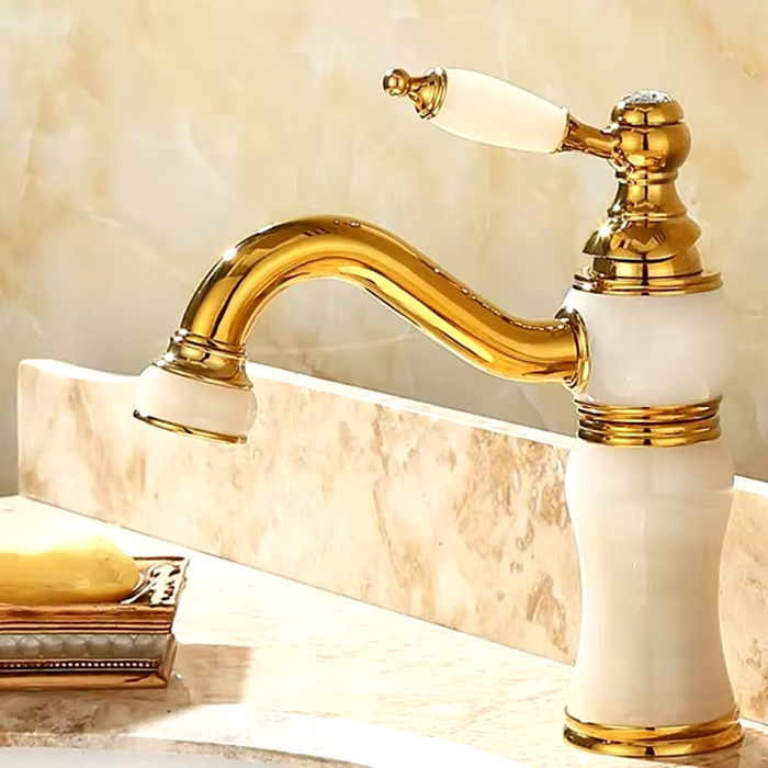 Luxury brass and jade basin faucet with gold finish and single-handle control.