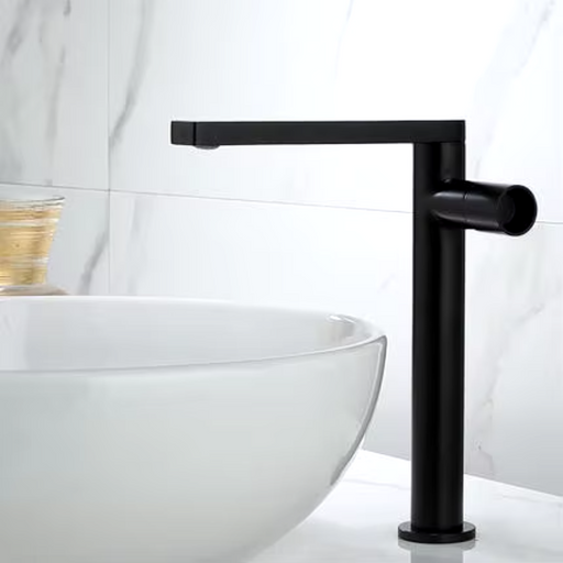 Tall modern basin faucet in sleek black finish beside white sink in a stylish bathroom.